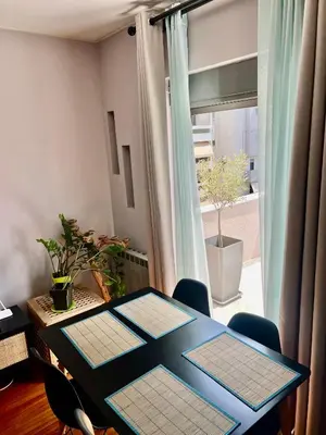 a dining room with a table and a window at Brand new brilliant apartment at Athenian Riviera in Athens