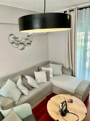 a living room with a couch and a table at Brand new brilliant apartment at Athenian Riviera in Athens