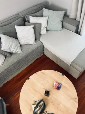 a living room with a couch and a wooden table at Brand new brilliant apartment at Athenian Riviera in Athens