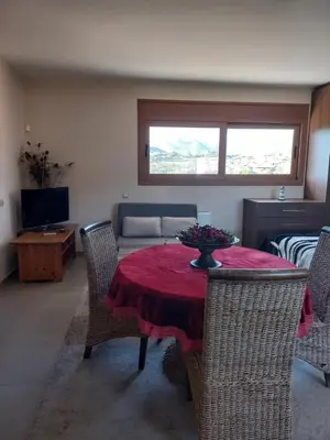 a living room with a table and chairs and a couch at Calmness Near the City in Metókhi