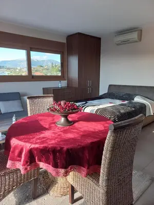 a room with a table with a red table cloth at Calmness Near the City in Metókhi