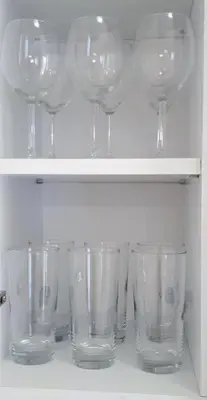 a row of wine glasses sitting on a shelf at Stylish apartment near Katechaki in Athens