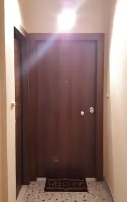 a door with a welcome mat in front of it at Stylish apartment near Katechaki in Athens