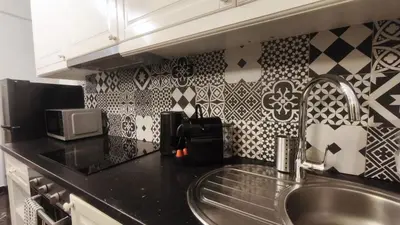 a kitchen with a sink and a microwave at 133 Sokratous, Black marble. in Athens