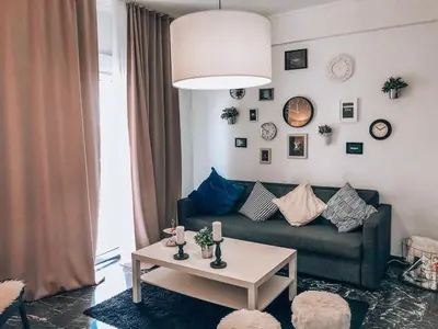 a living room with a couch and a table at 133 Sokratous, Black marble. in Athens