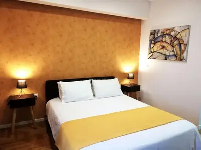 a bedroom with a large bed with two night stands at Modern flat in city center in Athens