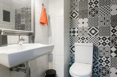 a white bathroom with a sink and a toilet at Modern flat in city center in Athens