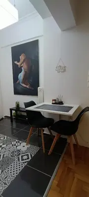 a dining room with a table and two chairs at Modern flat in city center in Athens