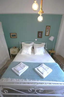 a bedroom with a bed with two towels on it at Central Apartment with Spacious Balcony in Athens