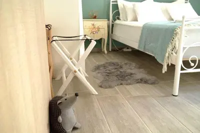 a bedroom with a bed and a teddy bear on the floor at Central Apartment with Spacious Balcony in Athens