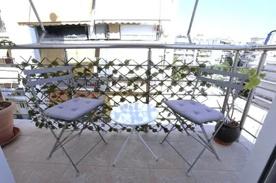 two chairs and a table on a balcony at Central Apartment with Spacious Balcony in Athens