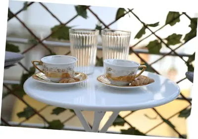two cups and saucers on a white table at Central Apartment with Spacious Balcony in Athens