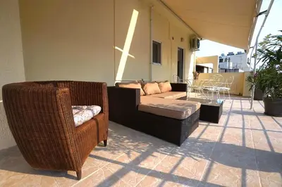 a living room with two chairs and a couch at Central Apartment with Spacious Balcony in Athens