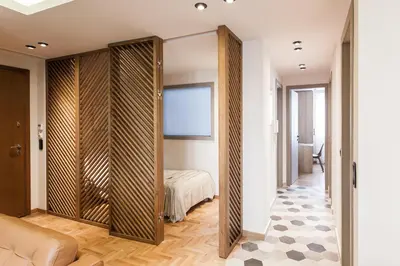 a bedroom with a sliding door leading to a bed at Modern Minimalist 3BD Apartment in Hilton District by UPSTREET in Athens