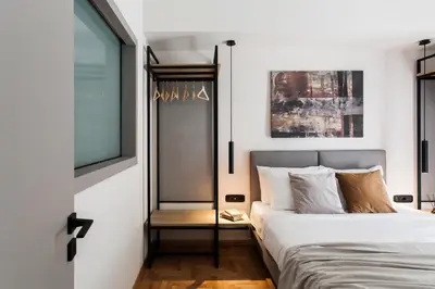 a bedroom with a bed and a window at Modern Minimalist 3BD Apartment in Hilton District by UPSTREET in Athens