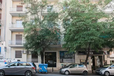 a group of cars parked in front of a building at Modern Minimalist 3BD Apartment in Hilton District by UPSTREET in Athens