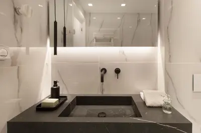 a bathroom with a black sink and a mirror at Supreme Luxury Suites by Athens Stay in Athens
