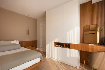 a bedroom with a bed and a tv on a wall at Supreme Luxury Suites by Athens Stay in Athens