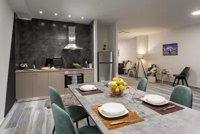 a kitchen and dining room with a table and chairs at Supreme Luxury Suites by Athens Stay in Athens