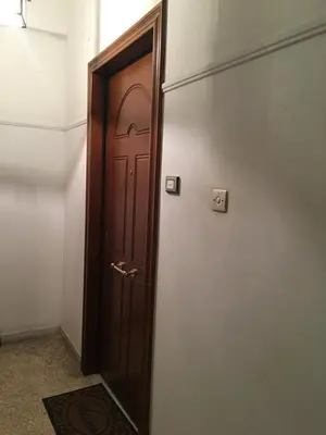 a wooden door in a room with a rug at The House of Electra in Athens