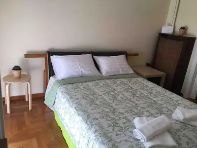 a bedroom with a bed with two towels on it at The House of Electra in Athens