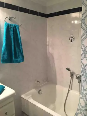 a bathroom with a bath tub with a blue towel at The House of Electra in Athens