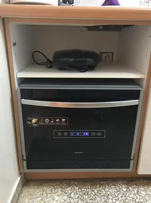 a cabinet with a television with a device in it at The House of Electra in Athens