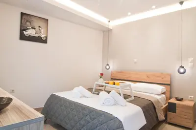 a bedroom with a large bed with towels on it at Home pleasure project in Athens