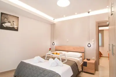 a bedroom with a bed with white towels on it at Home pleasure project in Athens