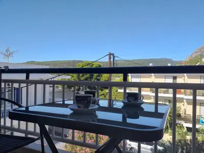 two coffee cups on a table on a balcony at agia marina riviera aigina in Agia Marina Aegina