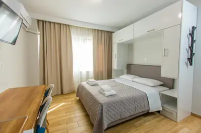 a bedroom with a bed and a table and a mirror at Athens Raise Acropolis Project in Athens