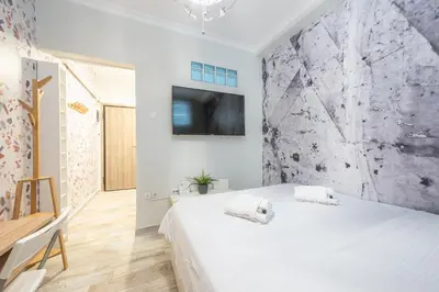 a bedroom with a bed and a tv on a wall at Welcoming Koukaki Home by Cloudkeys in Athens