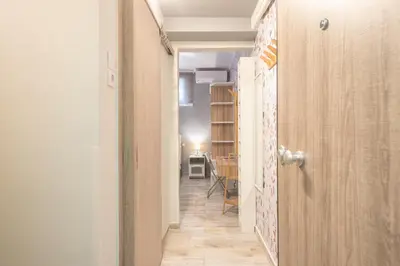 a hallway with a door leading to a dining room at Welcoming Koukaki Home by Cloudkeys in Athens