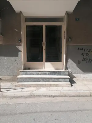 a front door of a building with concrete steps at Welcoming Koukaki Home by Cloudkeys in Athens