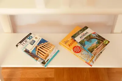 two books sitting on top of a white table at Freshly Refurbished flat, in Central Koukaki in Athens