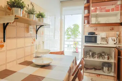 a kitchen with a table and a microwave at Freshly Refurbished flat, in Central Koukaki in Athens