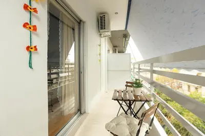 a balcony with two chairs and a table at Freshly Refurbished flat, in Central Koukaki in Athens