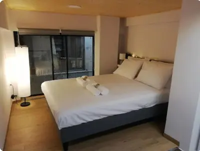 a teddy bear sitting on a bed in a bedroom at Heart of Athens Studio 25sqm in Athens