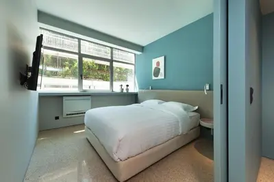 a blue bedroom with a bed and a window at Arcade Project Hi-end Apartments in Athens