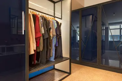 a walk in wardrobe with glass doors at Arcade Project Hi-end Apartments in Athens