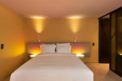 a bedroom with a large white bed with two pillows at Arcade Project Hi-end Apartments in Athens