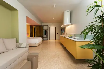 a living room with a couch and a bedroom at Arcade Project Hi-end Apartments in Athens