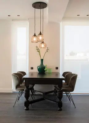 a dining room table with chairs and a vase on it at Glyfada South42 in Athens