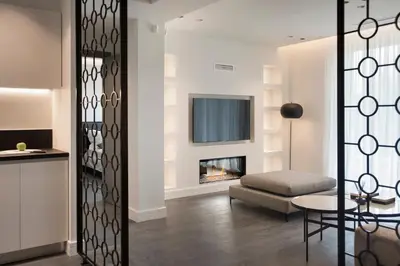 a living room with a fireplace and a couch at Glyfada South42 in Athens