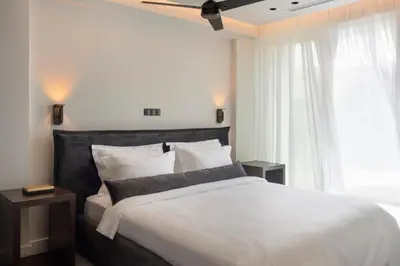 a bedroom with a large bed and a window at Glyfada South42 in Athens