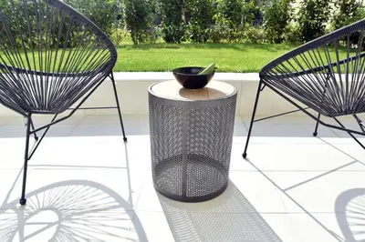 two chairs and a trash can on a patio at Glyfada South42 in Athens