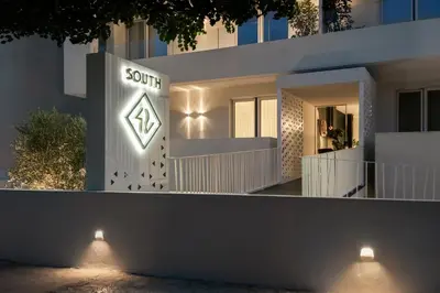 a white house with a sign on the side of it at Glyfada South42 in Athens