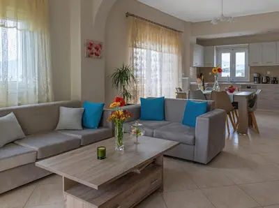 a living room with a couch and a table at Yellow house in Palaiá Fókaia