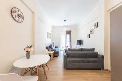 a living room with a couch and a table at Exeptional Apartment in Athens