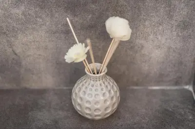 a vase with flowers in it sitting on a table at Exeptional Apartment in Athens